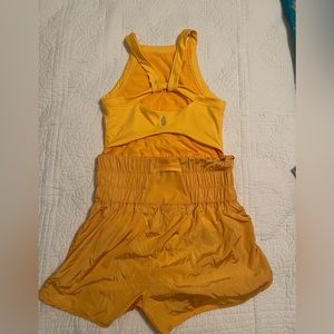 Free people movement high neck runsie in orange/yellow size M NEVER WORN